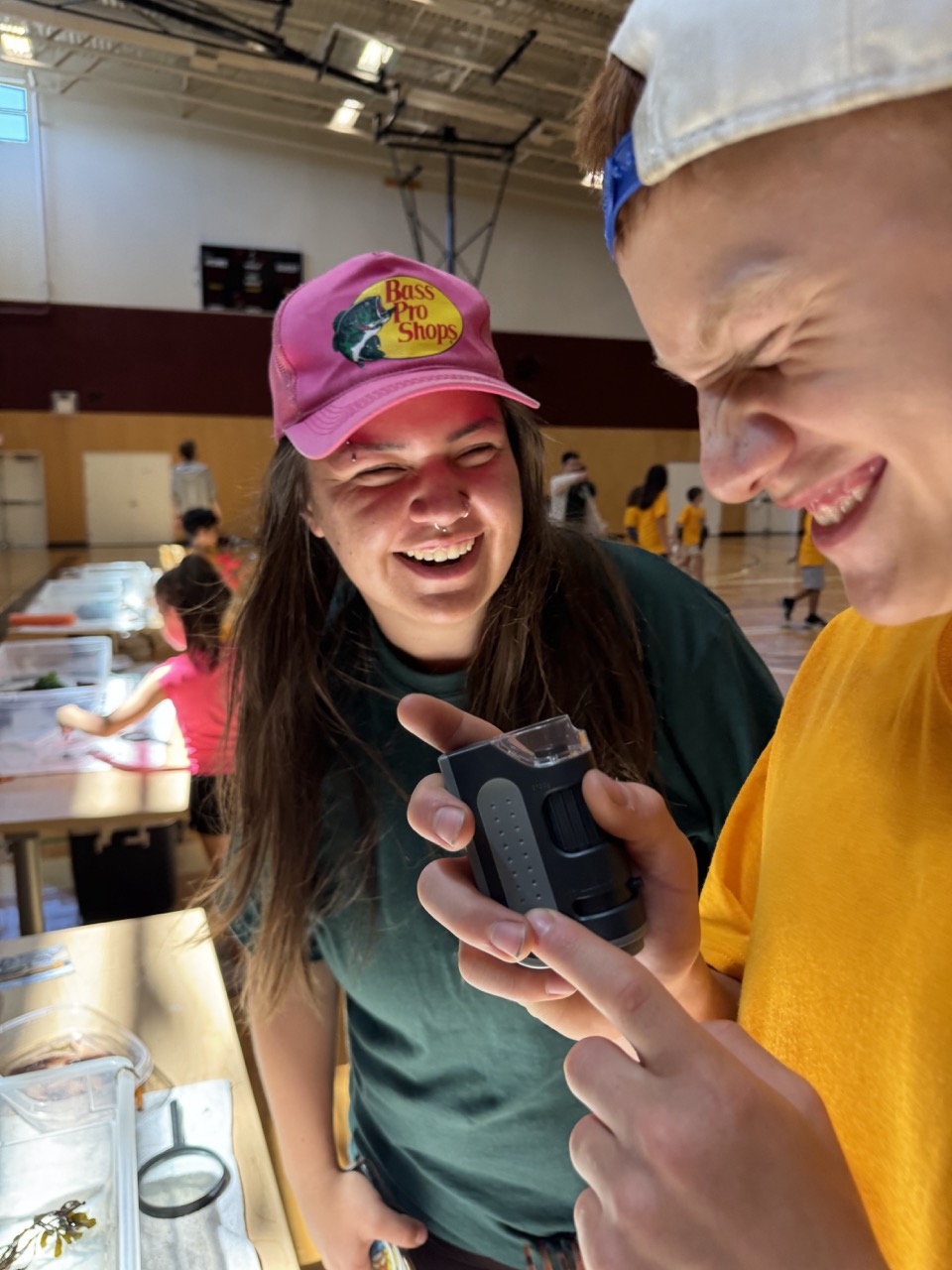 A volunteer smiles at a student.